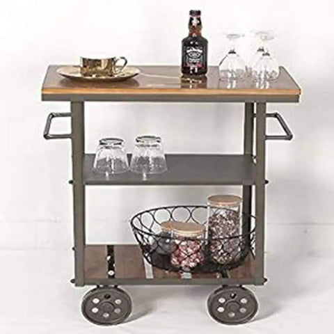Heavy Duty Metal Industrial Rolling Cart With Three Roomy Shelves For Kitchen Storage Bar Setup And Home Organization Top Shelf Iron Frame Wood Finish Smooth Glide Utility Trolley with drinks and glasses.
