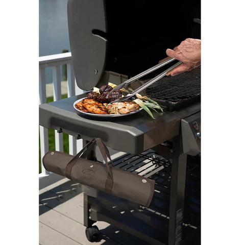 Using tongs from the Stainless Steel BBQ Grill Tools Set With Ergonomic Wood Handles to serve food at outdoor barbecue