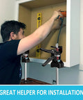 XKONE labor-saving arm jack pair; black lifting clamps with red springs mounted on a cabinet for panel lifting.