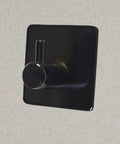Rock Solid Black Stainless Steel Adhesive Wall Hook For Coats Towels And Umbrellas With No Hassle Peel Stick Mount on smooth surface.