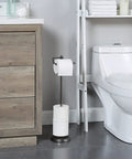 Free Standing Toilet Paper Roll Holder With Reserve Storage, Portable Floor Stand, Black Nickel Finish beside a toilet