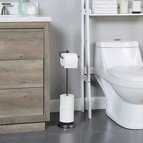 Free Standing Toilet Paper Roll Holder With Reserve Storage, Portable Floor Stand, Black Nickel Finish beside a toilet