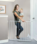 Hardware Mounted Metal Baby Gate For Stairs And Doorways, Walk Through Child Safety Barrier With Zero Threshold, Adjustable Up To Forty Inches Wide, Thirty Inches Tall, Crisp White, in use with a child.