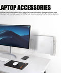 Acrylic Laptop Wall Mount mounted beside computer monitor on a desk, clear design providing ergonomic screen riser space.