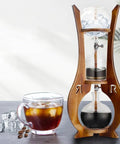 Skip The Store Bought Stuff And Sip Dope Flavor With This Portable Cold Brew Drip Tower Featuring Dual Adjustable Valves High Borosilicate Glass Large Capacity For Bold Iced Coffee on a counter.