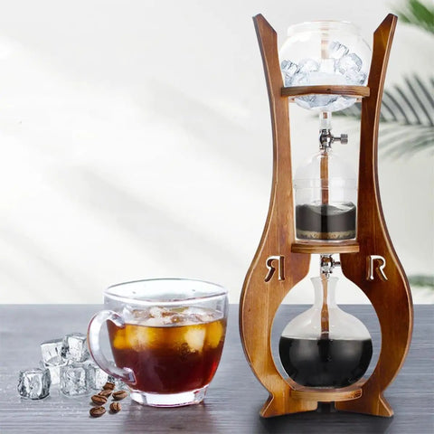 Skip The Store Bought Stuff And Sip Dope Flavor With This Portable Cold Brew Drip Tower Featuring Dual Adjustable Valves High Borosilicate Glass Large Capacity For Bold Iced Coffee on a counter.