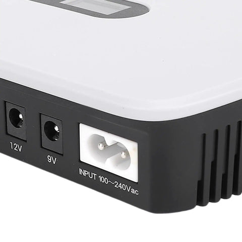 Close-up of Portable Ups Battery Backup 10400 Mah With Lcd Screen showing input and output ports for 5V 9V and 12V devices.