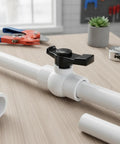 2 Inch Slip PVC Ball Valve Set With Double Socket Full Flow Port on workbench, tools nearby