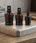 Get Your Car Running Smooth With This 3 Piece Swivel Socket Set Featuring 1/2, 3/8, And 1/4 Inch Drive Sizes Perfect For Tight Spaces With Ball Joint Adapter And Chrome Steel Build For Pros. Three chrome steel swivel socket adapters on a workbench, 1/2, 3/8, and 1/4 inch drives