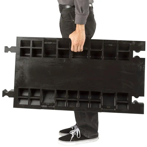 Person carrying Three Channel High Profile Drive Over Cable Protector For Heavy Duty Loads Up To 28,420 Pounds With Polyurethane Construction