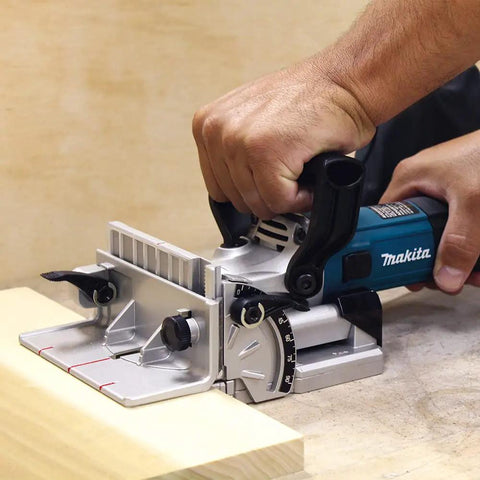 Person using Plate Joiner For Quick, Precise Biscuit Joinery With Five Point Six Amp Motor And Eleven Thousand RPM, Cast Aluminum Pivot Fence.