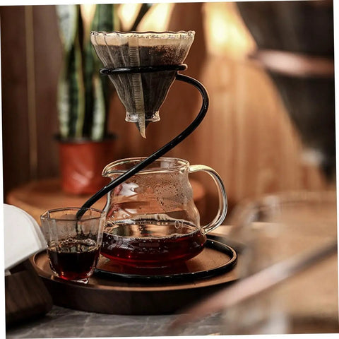 Coffee dripper holder and filter stand in use, black metal frame, brewing on a counter, ideal for home barista setups.