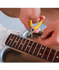 Using pliers from All In One Guitar Repair Kit With Neck Rest Cradle And Pro Grade Gig Ready Work Mat For Studio And Shop to cut strings