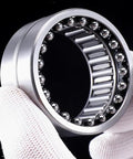 Top Shelf Heavy Duty Needle Roller Bearing NKIB5908 40X62X34mm held in hand with silver finish for high torque applications.