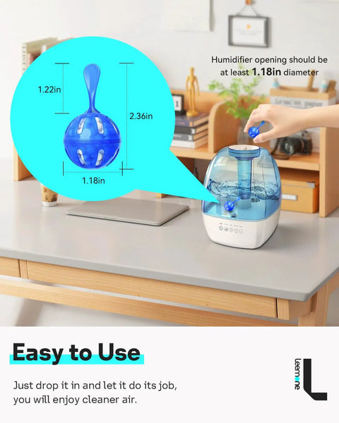 Person placing a blue Humidifier Cleaner 12 Pack Demineralization Cleaning Ball into a humidifier on a desk.