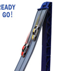 Flexible Dual Lane Race Track Set With U Turn Design for Kids, showing two diecast cars racing side by side down a slope.