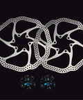 Two 180mm 6 Bolt Stainless Steel Disc Brake Rotors for Road, Mountain, MTB and BMX Bikes with bolts on a black background