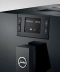 Close-up of Top Shelf Automatic Coffee Machine In Sleek Piano Black with control panel displaying espresso options.