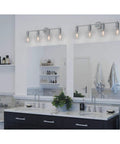 Hansford 4 Light Bath Vanity Fixture in Polished Nickel with Glass Globe Shades, shown above a modern master bathroom sink.