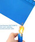 Demonstrating heat resistance of Heat Resistant Soldering Mat Silicone Repair Pad 932F 16x12 Inch Blue Workbench Pad with flame test.