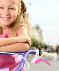 Girl with a bike featuring Kids Bike Brake Lever Set, 2 Pack Universal Brake Handles For Kids Bikes, Rosy Color, Easy Install.
