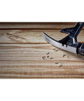 ToughSeries 22 Oz Demo Hammer With Magnetic Nail Starter and extended claw on wood surface, showing board grabbing capability.