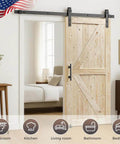 Unfinished Spruce Barn Door 42 In By 84 In With Classic British Brace Modern Style Solid Wood Single Door Ready To Stain Or Paint No Sliding Rail Kit Included Easy Assembly Old School Charm installed in a bright room setting.