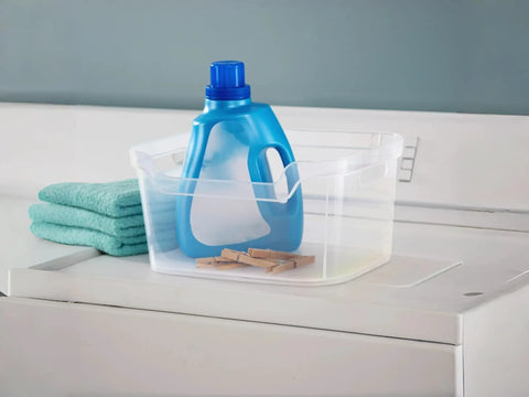Solid As A Rock Clear Storage Bins Three Pack Tough As Nails Transparent Plastic Crates Built For Closet Shelf And Garage Organizing Zero Fuss Setup Measuring 14 By 11 By 7 Inches with laundry detergent and clothespins.