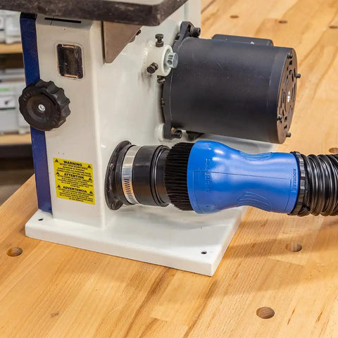 Fence Port Dust Brush For Router Table And Drill Press Cleanup With Flexible Two And Half Inch Hose attached to machine.