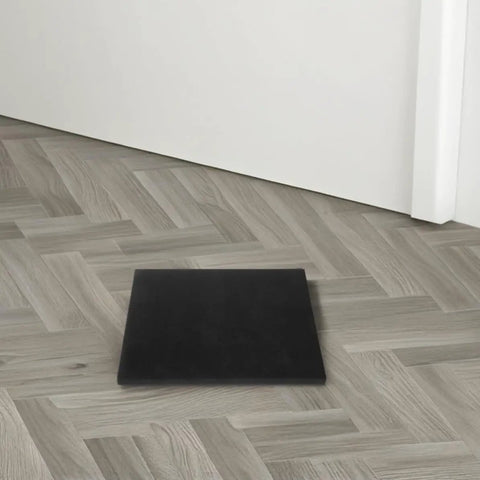 Black polyurethane foam padding sheet on wood floor for shipping and packaging pro grade cushioning pad for electronics and ceramics.