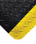 Diamond Plate Select UltraSoft Anti Fatigue Floor Mat corner detail, 4 ft by 2 ft, black with yellow edge, USA made for workshop use.