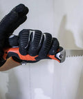 Side view of Klein Tools 31737 folding jab saw with orange/black handle and extended serrated blade.