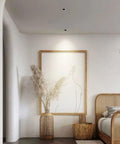 Top Shelf Eight Pack LED Downlights Slick Baffle Trim Anti Glare Recessed Spotlights Deep Cylinder Cob Ceiling Lights For Kitchen And Bath 20W 4000K Neutral illuminating a cozy bedroom with artwork.