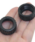 Hand holding two black screw caps from 10Pcs Universal 17mm Ball Joint Adapter Kit With Fixed Ring Nut And Screw Cap For Car Phone Mounts
