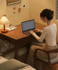 Top Shelf Solid Rubberwood Dual Gaming Desk With Built In Pine Drawers And Ample Knee Room For A Cozy Sit Stand Home Office Setup Right At Your Doorstep, woman working on laptop in stylish home office.