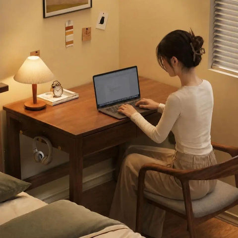 Top Shelf Solid Rubberwood Dual Gaming Desk With Built In Pine Drawers And Ample Knee Room For A Cozy Sit Stand Home Office Setup Right At Your Doorstep, woman working on laptop in stylish home office.