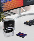 Slick Self Inking Office Date Stamp With Received Phrase And Dual Blue Red Ink for fast daily paperwork tasks on a desk.