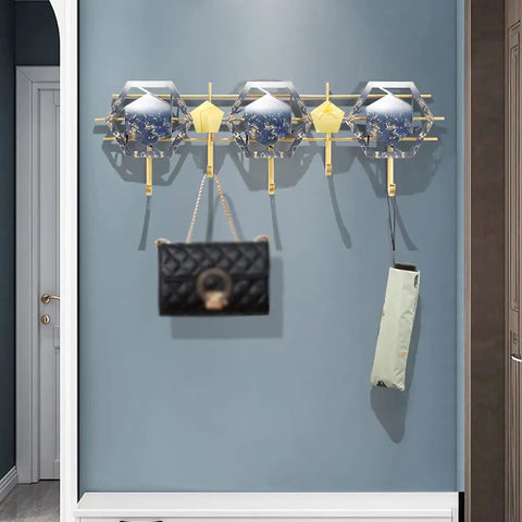 Heavy Duty Five Hook Wall Mount Coat Rack Sleek Steel Storage Bar For Zero Clutter Entryway Bedroom with bags and umbrellas.