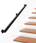 Kickass 7 Ft Indoor Stair Railing Featuring Matte Black Square Tube Handrail With Boss Level Non Slip Grip For Wall Mount Setup Totally Secure For Bathrooms Lofts And Kitchen Steps Rock Solid 500 Lb Rating installed along wooden steps.