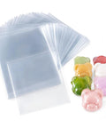 4 X 4 Inch Heat Shrink Bags 300 Pack Slick Glossy Polyolefin Film with colorful bear-shaped soaps beside them.