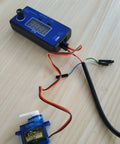 4Channel RC Servo Tester and ESC Consistency Tester with throttle display for RC helicopter, airplane, car motor on wooden table