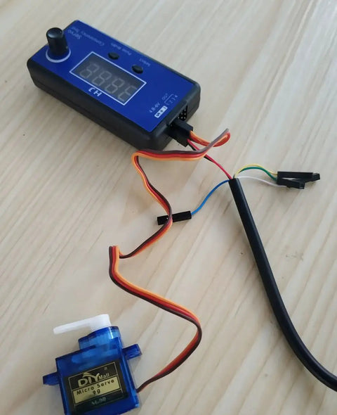 4Channel RC Servo Tester and ESC Consistency Tester with throttle display for RC helicopter, airplane, car motor on wooden table