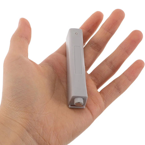 4 Pack Invisible Push Latch Kit For Wardrobe And Cabinet Doors, held in hand, showing size and detail of handle-free mechanism