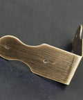 Solid brass corner guard in antique bronze finish for furniture protection, part of 8 piece kit for tables and jewelry boxes.