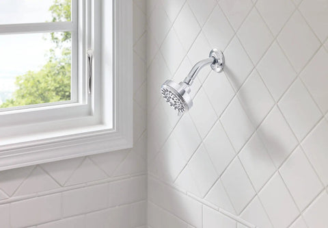 Ignite Chrome Five Function Shower Head With 2.5 GPM High Pressure Spray installed in bathroom with white tile wall.