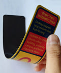 Person holding a Six Pack Magnetic Lockdown Strip for Iron Door Frames with High Density Magnets and durable yellow PVC surface, reusable.