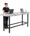 Top Shelf Standing Bar Table With Twelve Built In AC Outlets And Sturdy Footrest Crafted For Cafes Bars And Modern Offices in use.