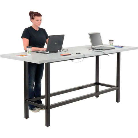Top Shelf Standing Bar Table With Twelve Built In AC Outlets And Sturdy Footrest Crafted For Cafes Bars And Modern Offices in use.