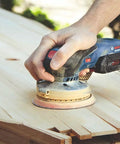 18V Brushless 5 Inch Cordless Random Orbit Sander Bare Tool With Ergonomic Palm Grip in use on a wooden surface