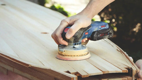 18V Brushless 5 Inch Cordless Random Orbit Sander Bare Tool With Ergonomic Palm Grip in use on a wooden surface